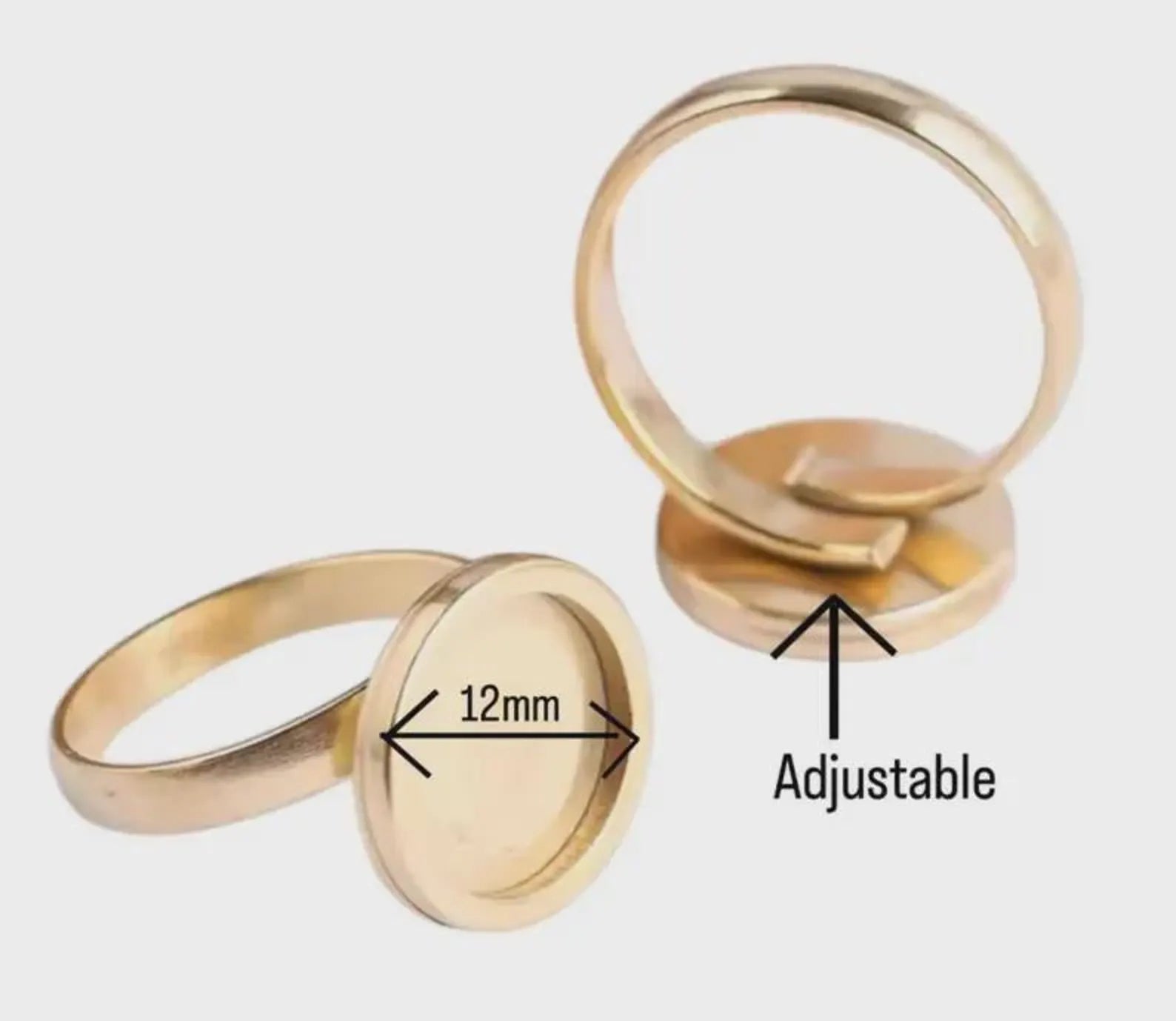 Two gold rings with adjustable feature on a white background