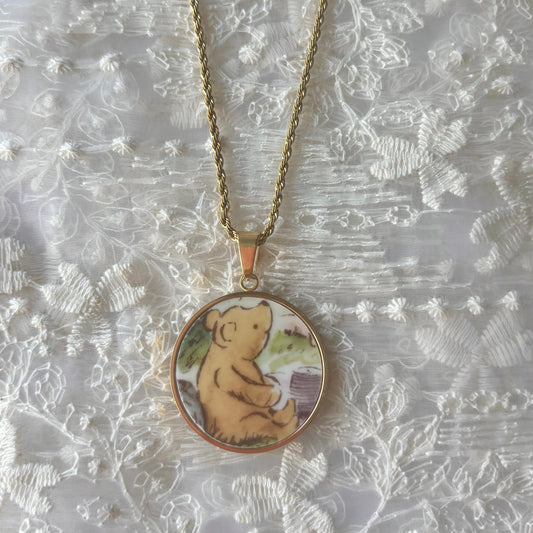 Necklace with a pendant featuring a bear design on a textured white background
