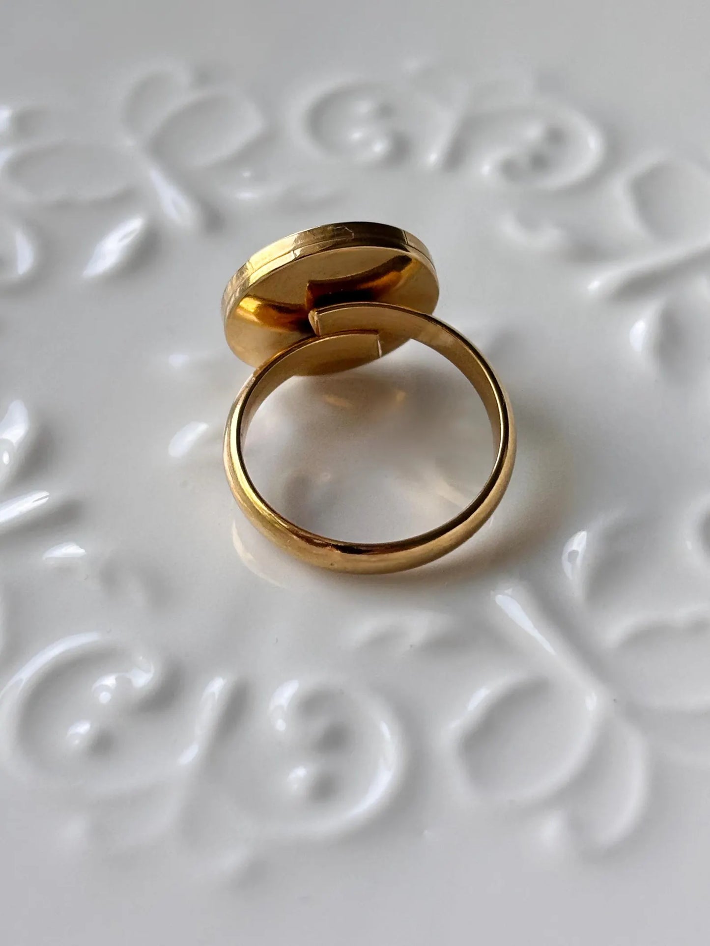 Gold ring with a textured white surface