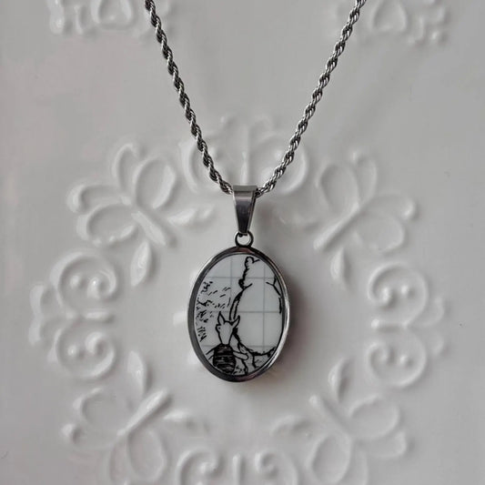 Necklace with a pendant featuring a bee design on an embossed gray background